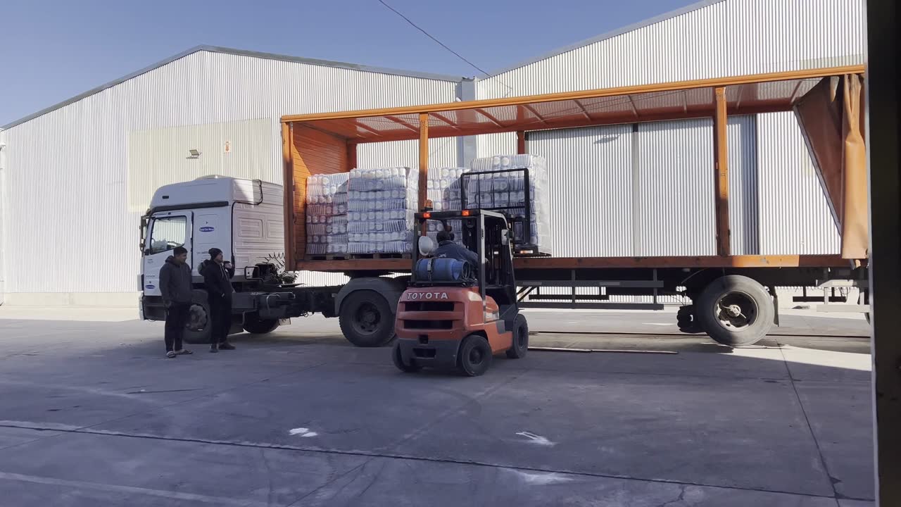 Forklift loading a truck at a warehouse
